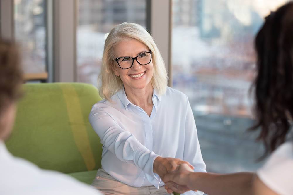 Confident Mature Woman Shaking Hand