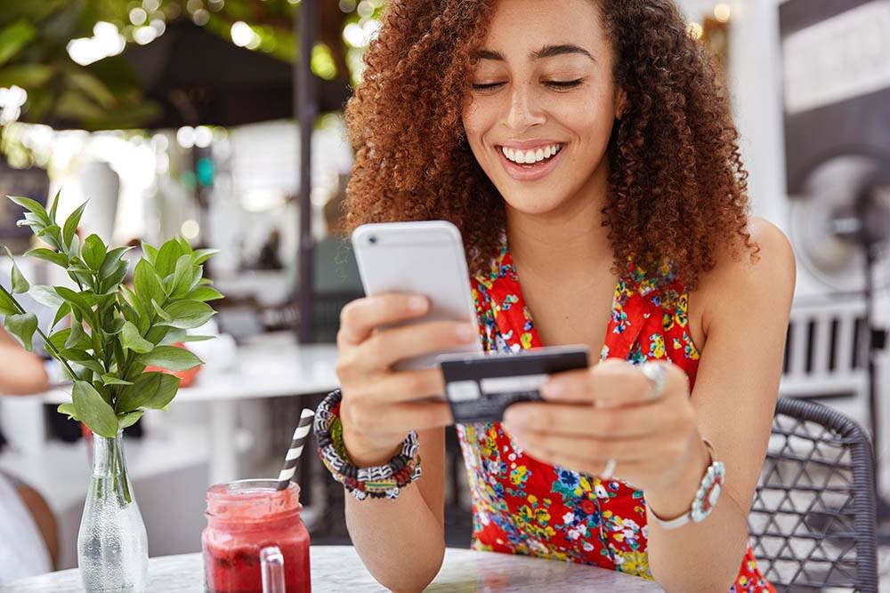 Female Uses Credit Card for Mobile Shopping