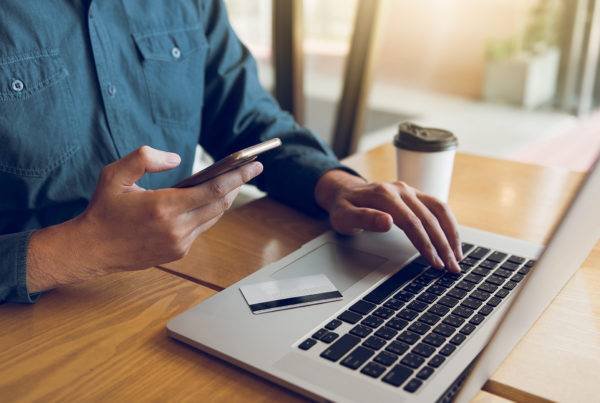 Man Using Laptop and Mobile