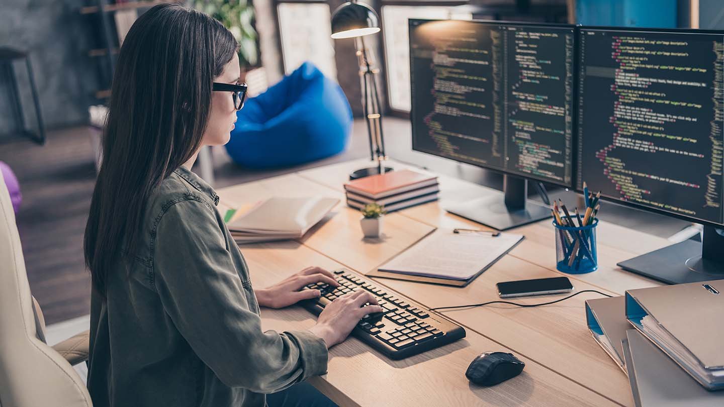 A virtaul system admin working at their computer.