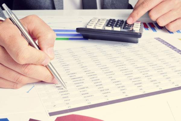 Person Checking Data on Sheet