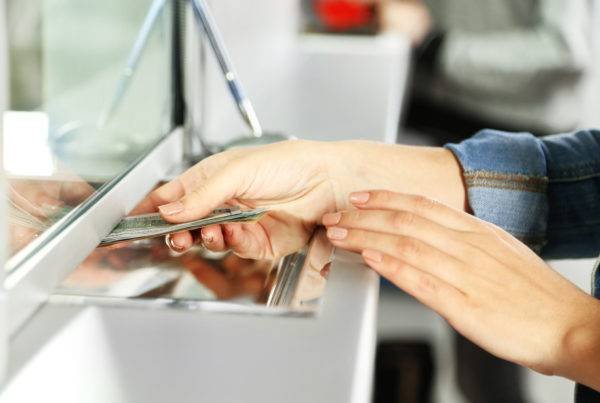 Man Passing Cash from Window