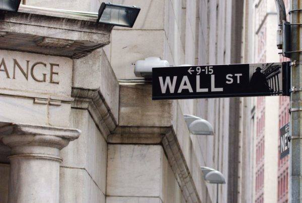 A sign reading wallstreet in front of an exchange building