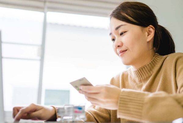 A young woman working remotely at her computer.