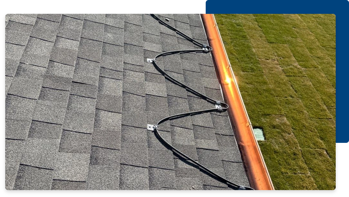 Benefits of a Heated Roof System, part of a roof with a heated roof system on it with a blue square behind the image in the top right corner