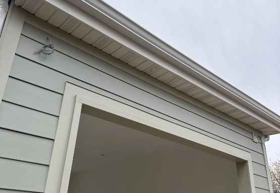 Siding, part of a home featuring siding and part of a window